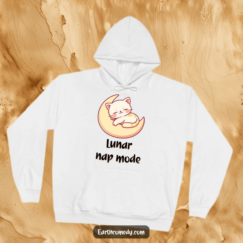 Funny hoodie featuring a contented, stylized cat character napping on a crescent moon-shaped cushion, offering cozy, humorous vibes.