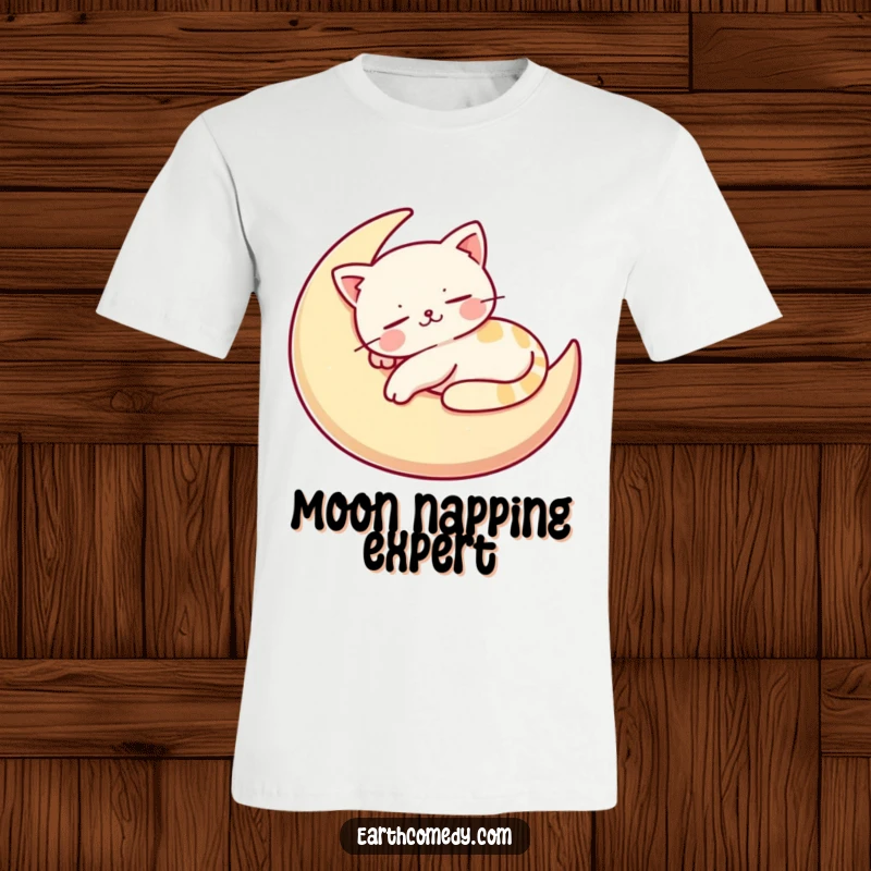 Funny t-shirt displaying a happy, stylized cat character sleeping soundly on a crescent moon cushion, perfect for relaxation.